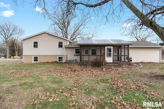 back of house with a lawn