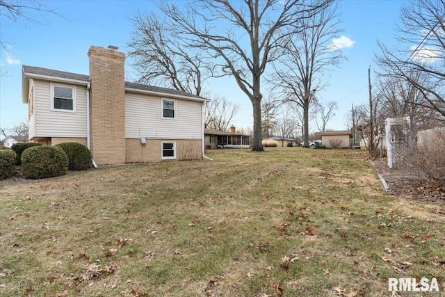 view of side of property with a lawn