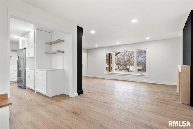 unfurnished living room featuring light hardwood / wood-style floors