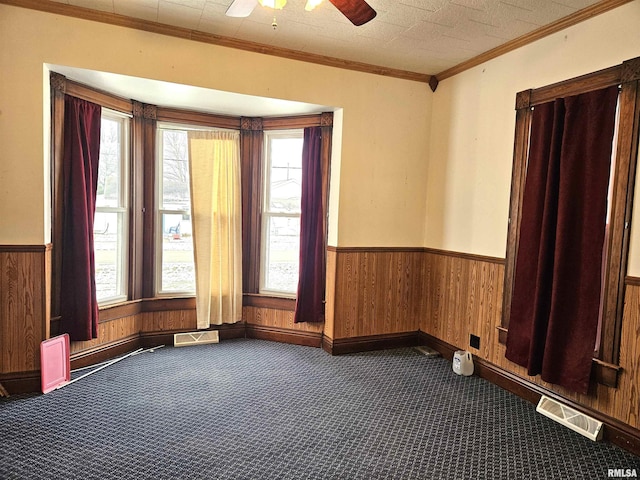 spare room with carpet flooring, ceiling fan, and ornamental molding