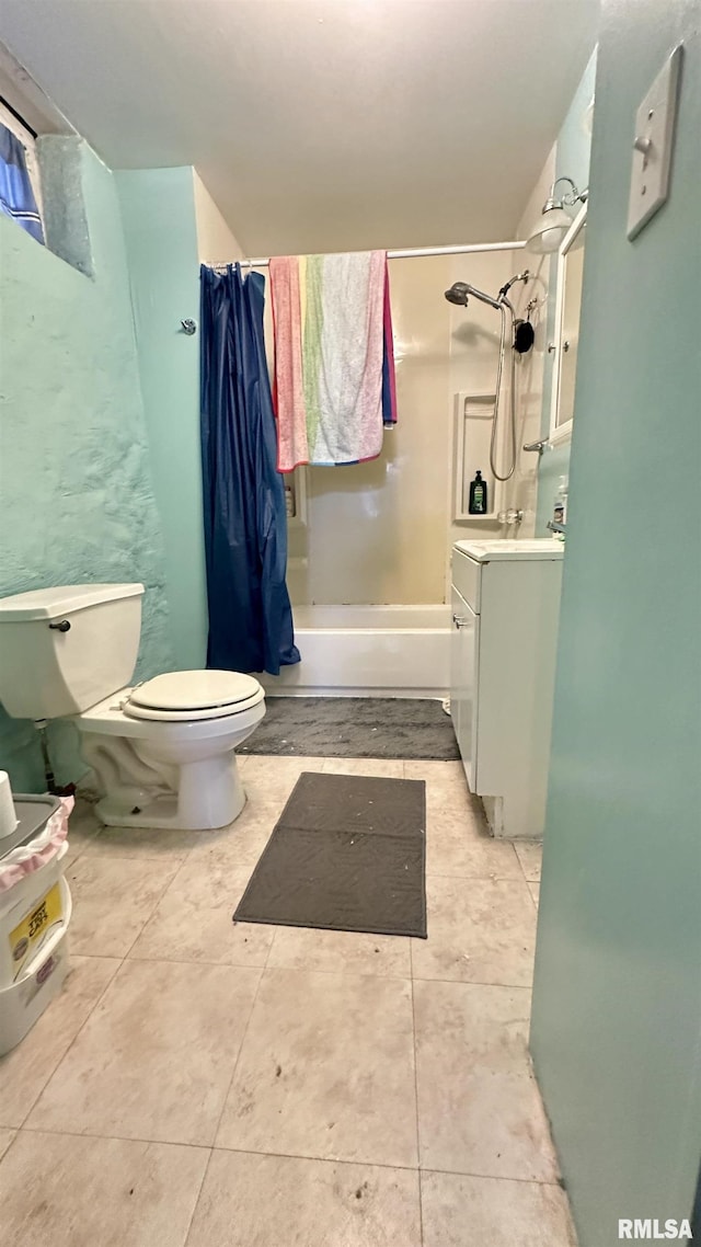 full bathroom featuring tile patterned flooring, vanity, toilet, and shower / tub combo with curtain