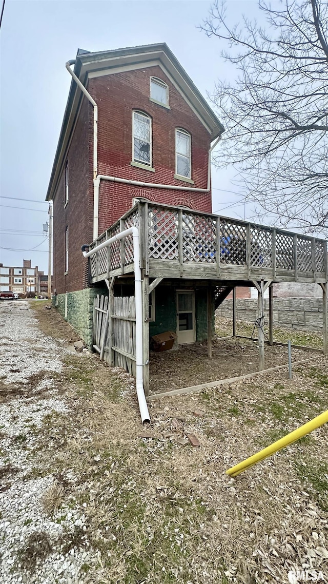 rear view of property featuring a wooden deck