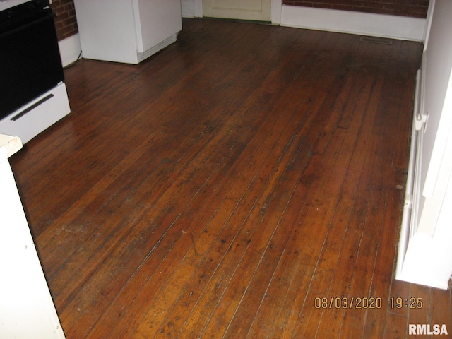 interior details featuring stove and wood-type flooring