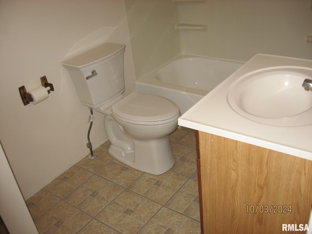 bathroom featuring a bathtub, vanity, and toilet