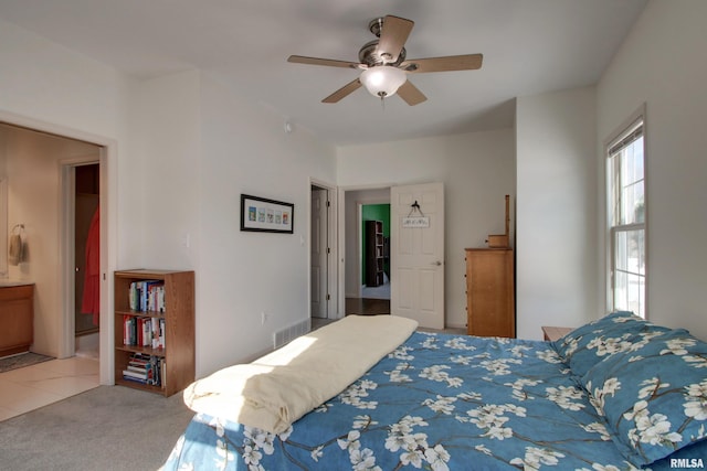 bedroom with connected bathroom, ceiling fan, and carpet floors