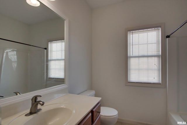 bathroom with vanity, a healthy amount of sunlight, and toilet