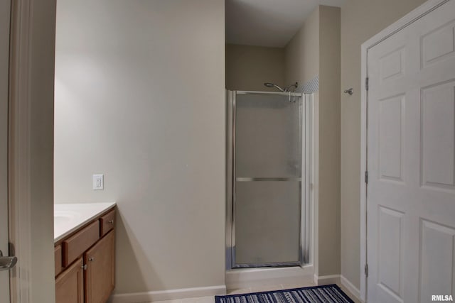 bathroom featuring vanity and a shower with shower door