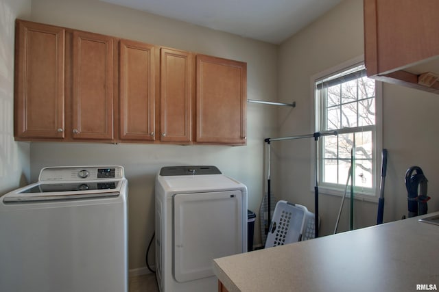 laundry room with washer and dryer and cabinets