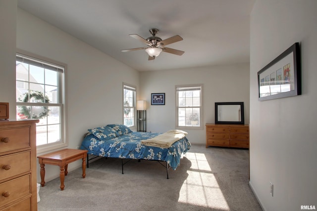 bedroom featuring ceiling fan and light carpet