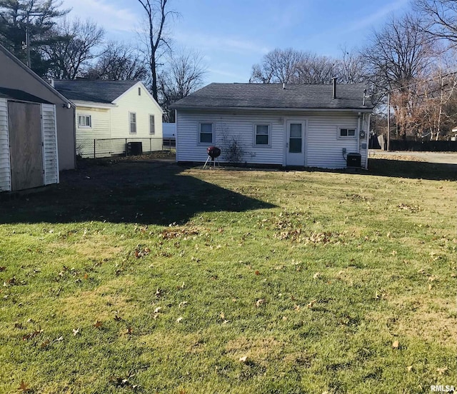 back of property with a yard and cooling unit