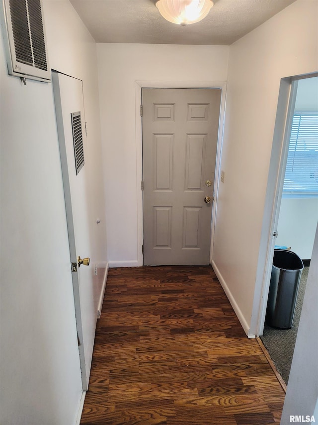 corridor featuring dark hardwood / wood-style flooring