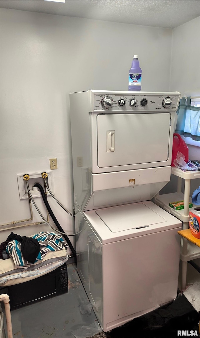 laundry area featuring stacked washer and dryer