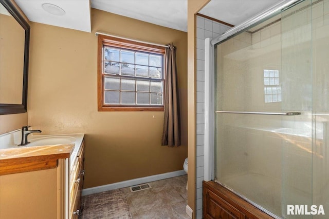 bathroom with vanity, toilet, and walk in shower