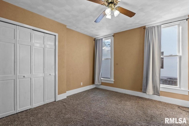 unfurnished bedroom with carpet flooring, ceiling fan, and a closet