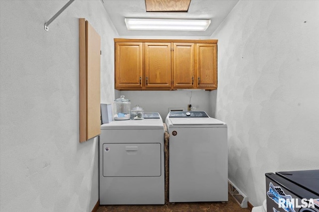 laundry room featuring cabinets and washing machine and clothes dryer