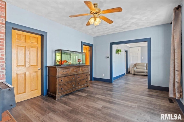 interior space featuring a textured ceiling, ceiling fan, and dark hardwood / wood-style floors