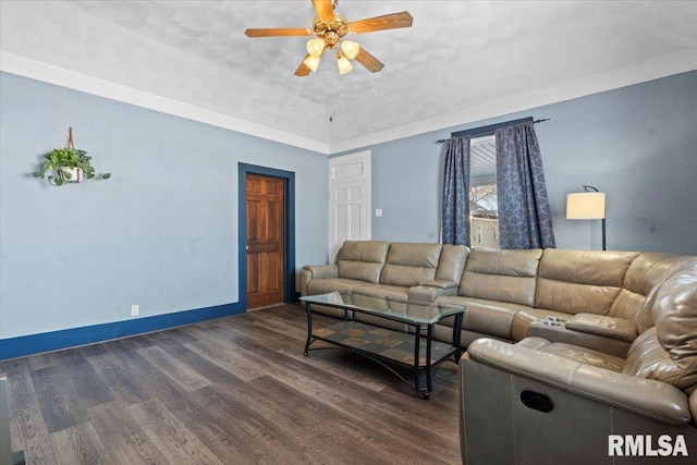 living room with dark hardwood / wood-style floors, ceiling fan, and ornamental molding