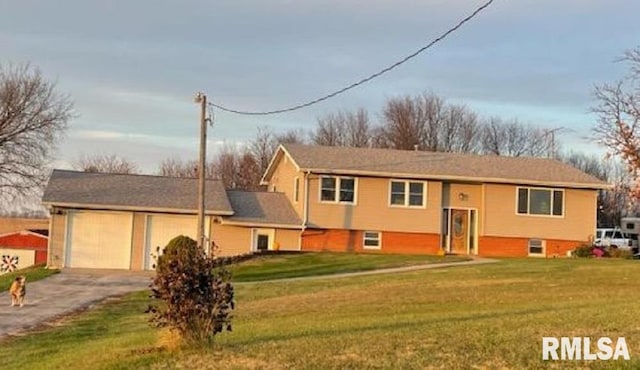 view of front of home with a garage and a front lawn