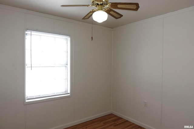 unfurnished room with ceiling fan and dark wood-type flooring