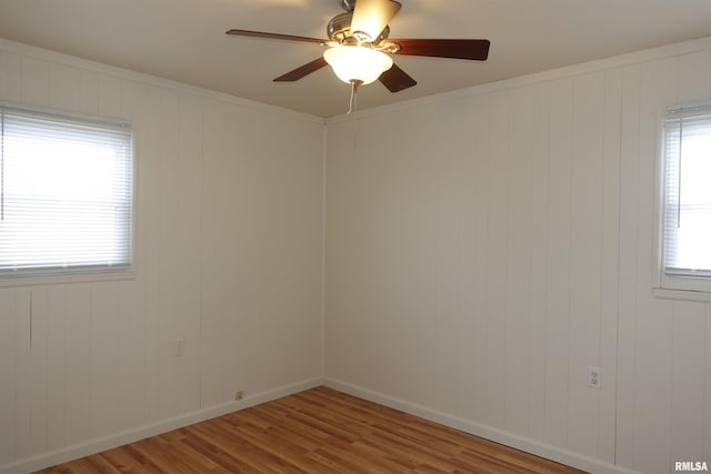 empty room featuring light hardwood / wood-style flooring, plenty of natural light, crown molding, and ceiling fan