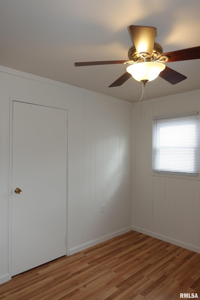 unfurnished room featuring hardwood / wood-style flooring and ceiling fan