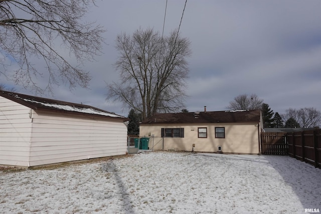 view of snow covered rear of property