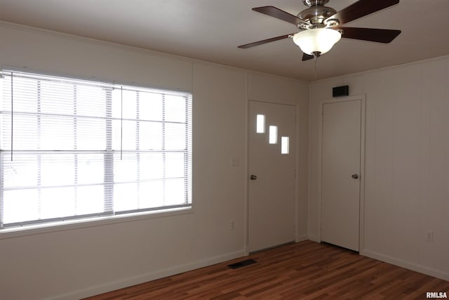 foyer with dark hardwood / wood-style floors, plenty of natural light, and ceiling fan