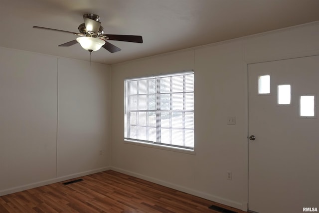 spare room with ceiling fan and dark wood-type flooring