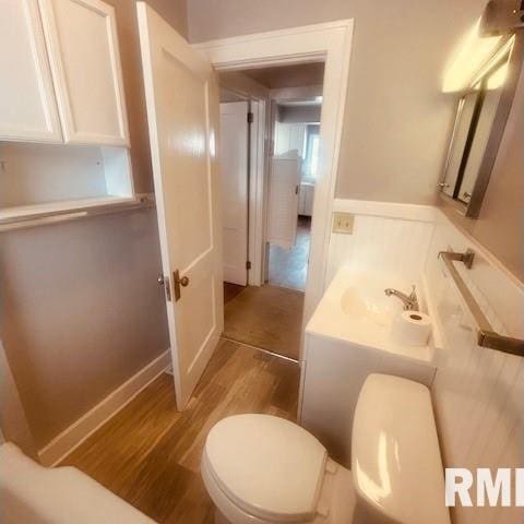 bathroom featuring hardwood / wood-style floors, vanity, and toilet