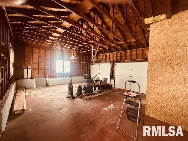 miscellaneous room with concrete floors and lofted ceiling