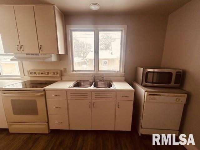 kitchen featuring sink, white appliances, white cabinets, and dark wood-type flooring