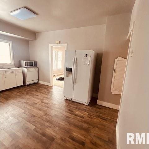 kitchen featuring wood-type flooring, white cabinets, and white fridge with ice dispenser