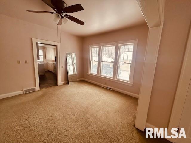 carpeted empty room with ceiling fan