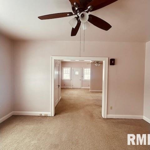 carpeted spare room with ceiling fan