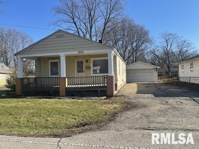 bungalow featuring an outdoor structure, a front yard, a porch, and a garage