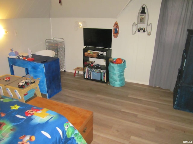 bedroom with wood-type flooring and lofted ceiling