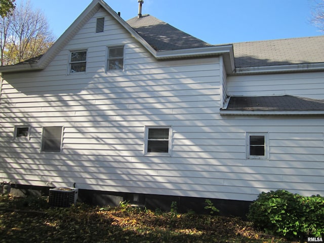 view of side of home with central air condition unit