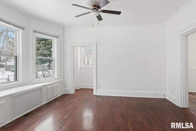 empty room with crown molding, dark hardwood / wood-style floors, and ceiling fan