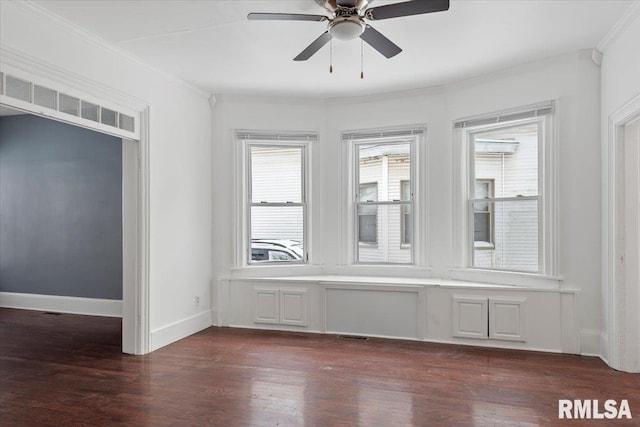 unfurnished room with ornamental molding, ceiling fan, and dark hardwood / wood-style flooring