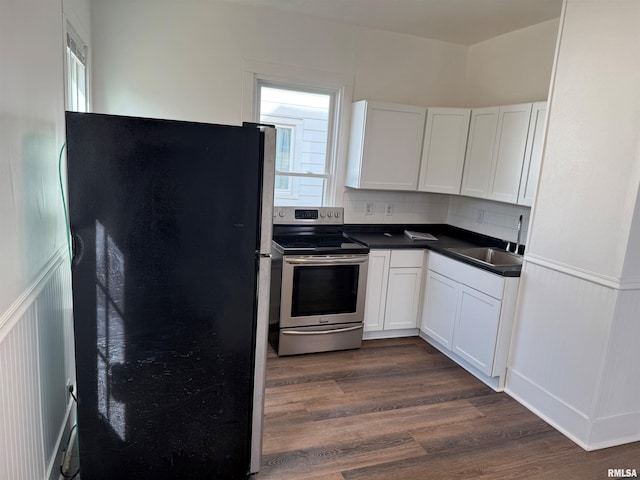 kitchen with a healthy amount of sunlight, sink, white cabinets, and appliances with stainless steel finishes