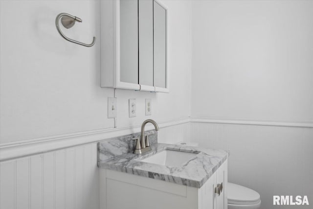 bathroom featuring vanity and toilet