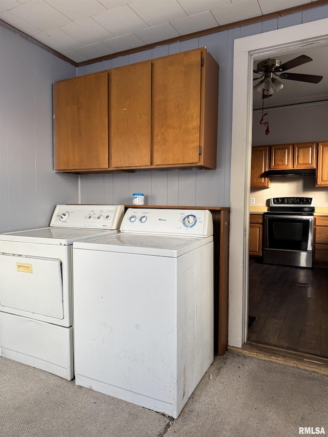 clothes washing area with cabinet space, washing machine and dryer, and ceiling fan