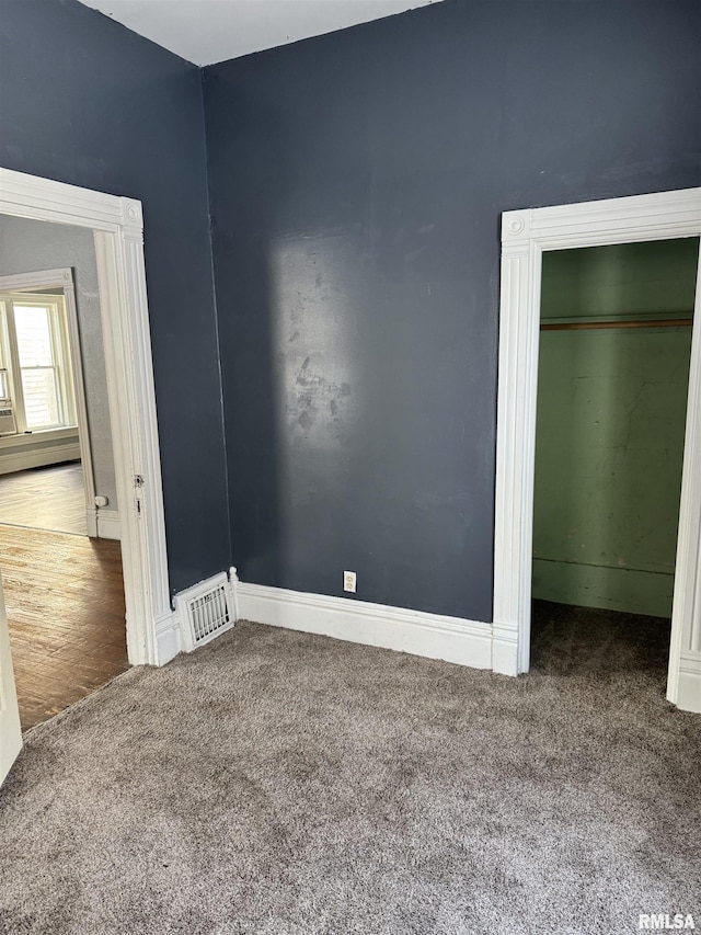 unfurnished bedroom featuring visible vents and carpet flooring