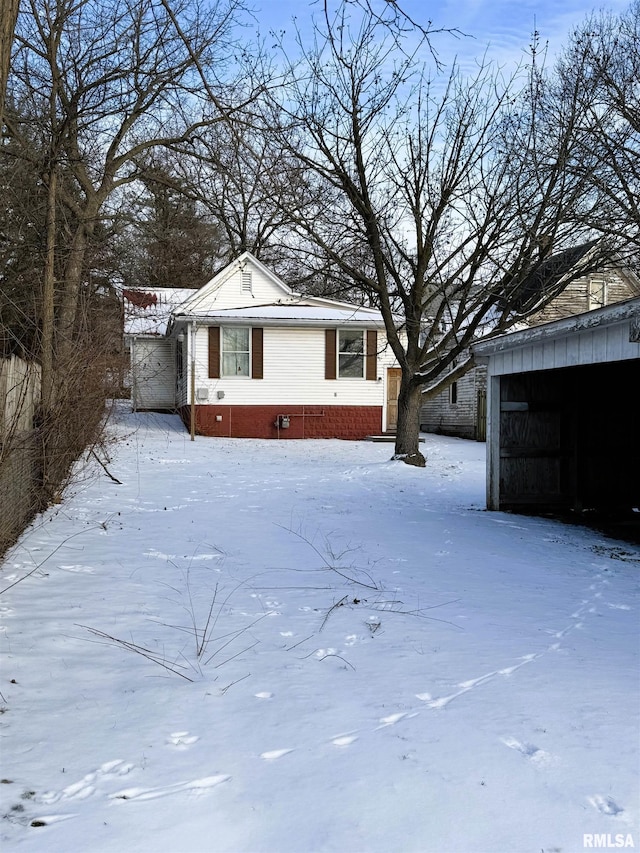 view of snowy exterior featuring crawl space and a garage