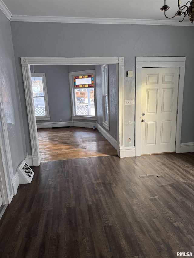 foyer with crown molding, wood finished floors, and baseboards