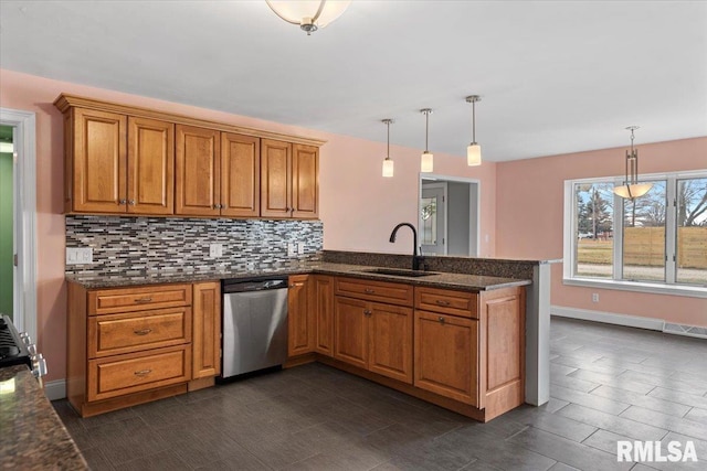 kitchen with kitchen peninsula, tasteful backsplash, sink, decorative light fixtures, and dishwasher