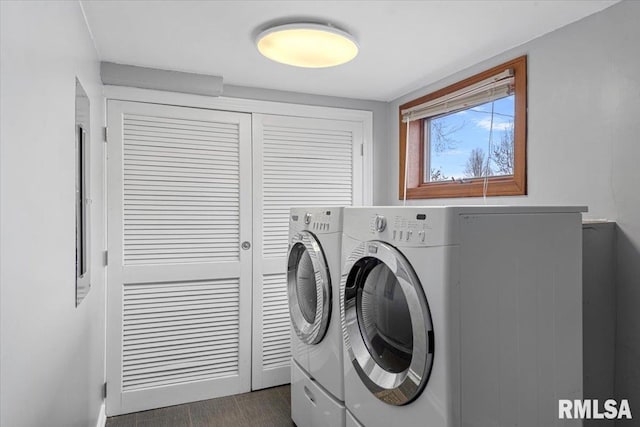 clothes washing area with washing machine and dryer