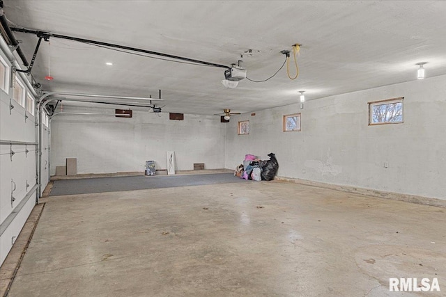 garage with a garage door opener and ceiling fan