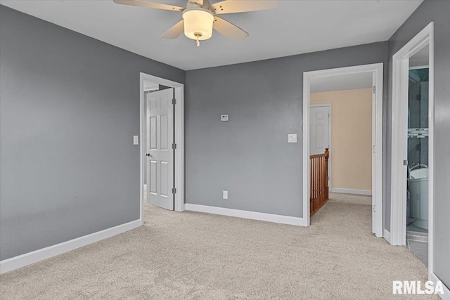 unfurnished bedroom with ceiling fan, light carpet, and connected bathroom