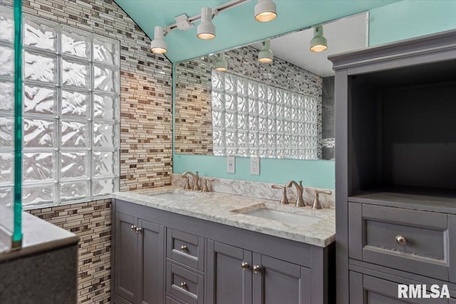 bathroom featuring vanity and vaulted ceiling